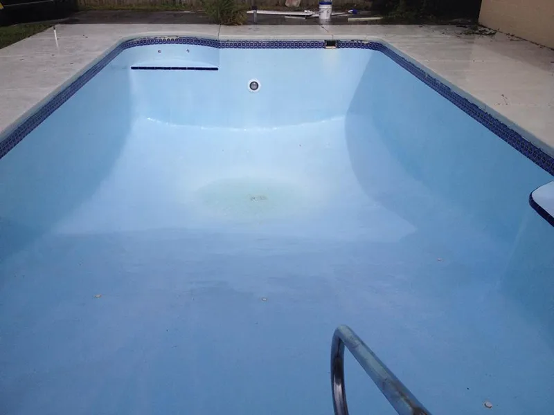 Empty swimming pool after professional cleaning by Kristi's Pool Service.